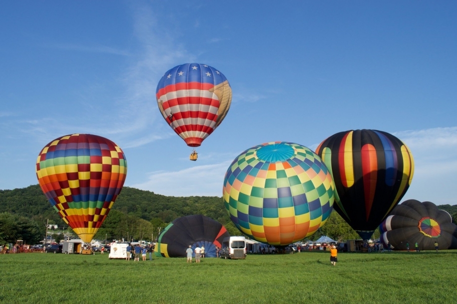 Hot air balloons inflating and rising into the skies over Warren County, New Jersey.